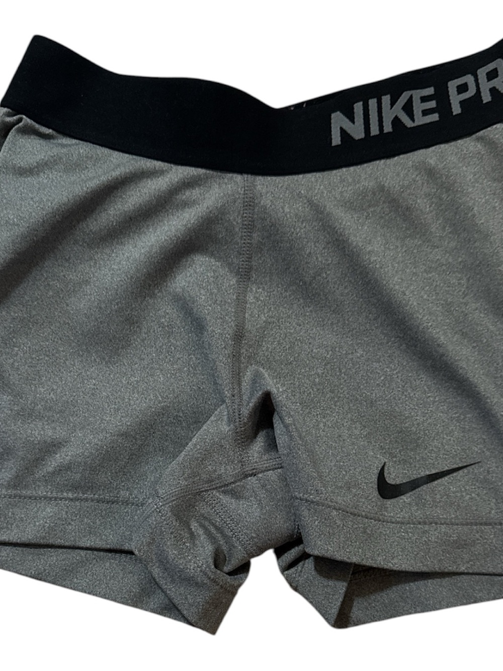 Nike white label with black Swoosh and text